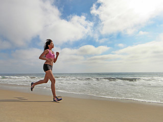 Female Runner Running at the Beach Jogging