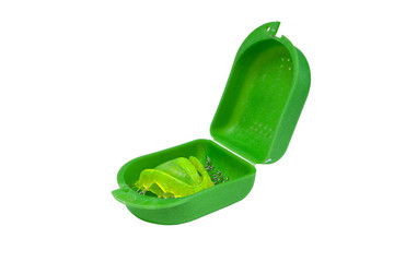 Acrylic dental retainer isolated on white in box