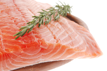 raw salmon fillet on wood and rosemary