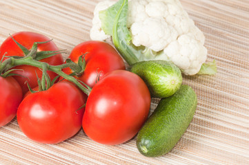 Vegetables, tomatoes, cucumbers, cauliflower on a table