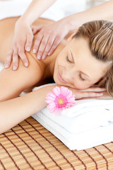 Fototapeta na wymiar Relaxed young woman having a back massage