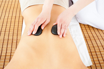 Close-up of a caucasian woman receiving a back massage with hot