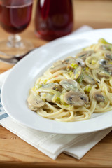Spaghetti with mushroom sauce and wine in background