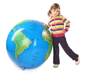 little girl standing near big inflatable globe