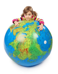 little girl look out of big inflatable globe and embracing it