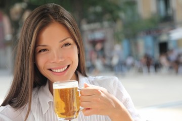 Woman drinking beer at cafe