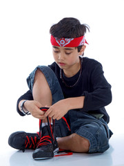 Fototapeta na wymiar boy tying his shoelaces isolated on white background