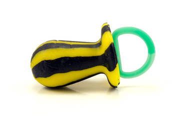 black and yellow candy pacifier over white