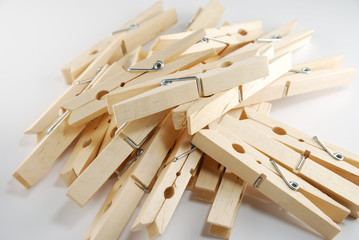 The wooden clothespin pile up on the white background