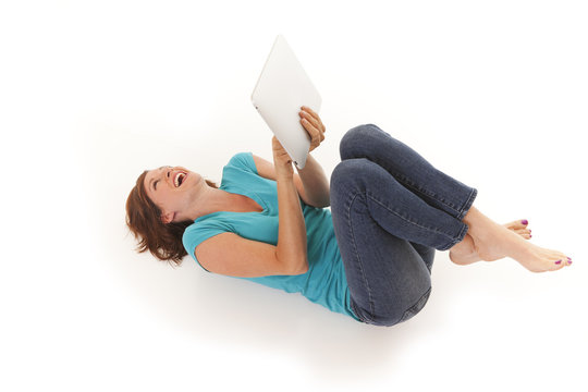 Young Woman Casually Laying On Floor With I Pad