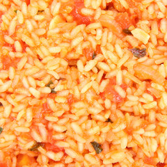 Food background: Risotto with tomatoes in close up