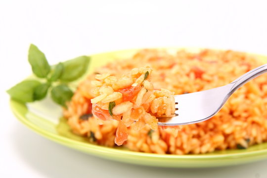 Risotto with tomatoes and basil - some of it on a fork