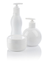 white cosmetical spray bottle and cream