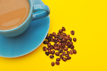 blue cup of coffee with coffee grain