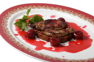 meat in a sweet sauce on a plate. isolated on a white background