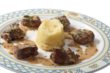 meat with garnish on a plate. isolated on a white background