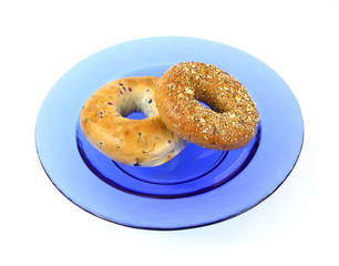 Blueberry and whole wheat grain bagels on blue dish