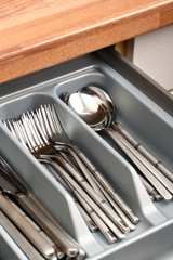 Silver cutlery placed in kitchen drawer