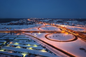 night winter cityscape with big interchange, lighting columns