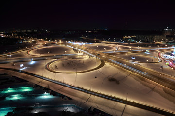 night winter cityscape with big interchange, lighting columns