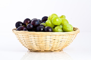 green and blue grapes in a braided dish