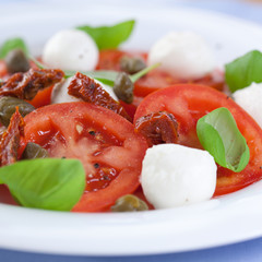 Caprese salad with capers and dry tomatoes