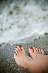 Woman feet - lonely day at the beach