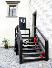 Decorated enter door - red steps in Czech Krumlov