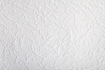 Surface of white wallpaper having the relief
