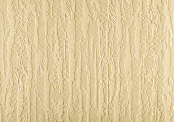Surface of beige wallpaper having the relief