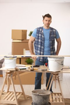Young man preparing to paint new home