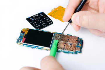 Electronics repair mobile phone and engineer hand