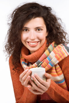 Beautiful smiling woman in muffler holding a cup of tea