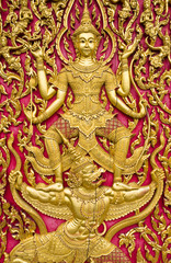 Fototapeta premium Buddha carved gold paint on church door