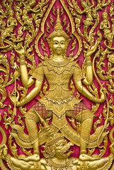 Buddha carved gold paint on church door