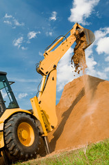 Backhoe loader excavator equipment at sand construction works