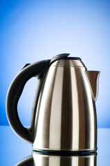 Shiny kettle against the colorful gradient background