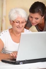 Elderly woman learning how to use computer