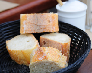little roll breads in basket on table