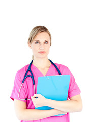 Thoughtful female surgeon holding a clipboard
