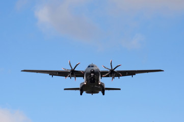 unmarked propeller cargo aircraft on landing approach