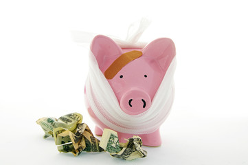 bandaged piggy bank with cash