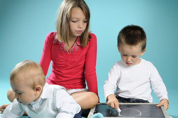 children writing math symbols on black board