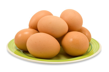 fresh brown chicken eggs on a plate