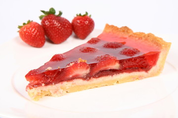 Piece of Strawberry Tart on a white plate with strawberries