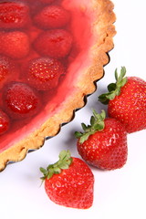 Strawberry Tart in a tart pan and some strawberries in close up
