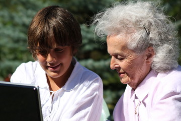 jeune garçon et son arrière grand-mère utilisant un ordinateur