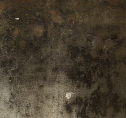 very dark brown black grunge on a gray stone cut wall