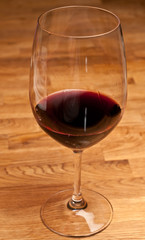 Glass of red wine on a wood table