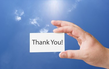 Thank you text on white paper card in hand